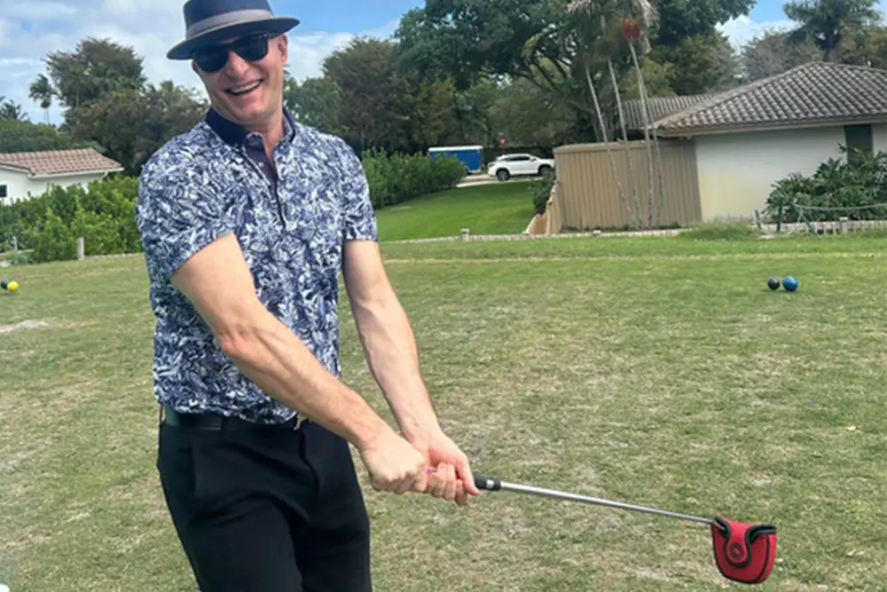 Ryan at Golf Course Taking a Golf Swing for Funders Forum and Brokers Expo 2026