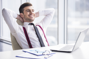 A time for relax. Young happy businessman is relaxing in his office.